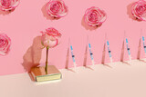 Creative concept of beauty injections. Syringe with toxin and rose on pastel background