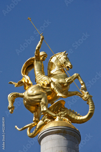 Gold sculpture of St. George slaying a dragon atop a column in Freedom Square, Tbilisi, Georgia