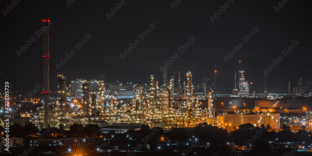 The aerial view of oil refinery factory and oil storage tank industry plant power at twilight and night sky background.