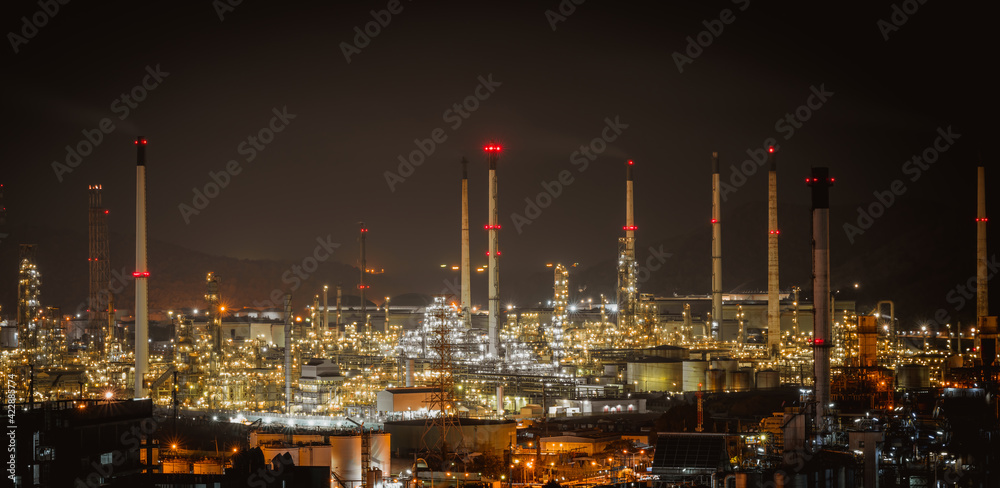 Fototapeta premium The aerial view of oil refinery factory and oil storage tank industry plant power at twilight and night sky background.