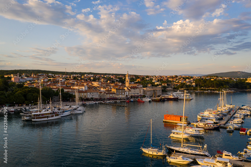 Sunset over the Krk old town and harbor in the Krk island in Croatia in summer