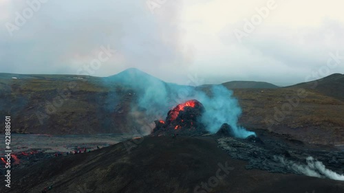 Aerial view of blue sulfur smoke rising from a erupting volcano crater, in Iceland - circling, drone shot photo