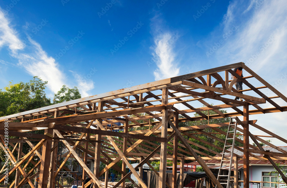 Standard wooden structure building with mounting distance, installation of wooden beams in the construction of the roof truss system of the house. Standard wooden structure building with mounting distance, installation of wooden beams in the construction of the roof truss system of the house.