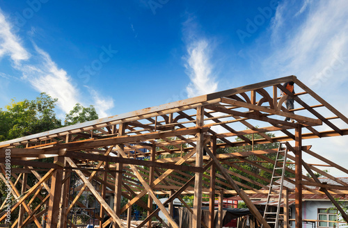 Standard wooden structure building with mounting distance, installation of wooden beams in the construction of the roof truss system of the house.