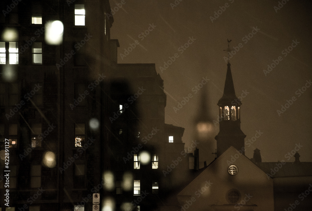 A church spire in Old Québec City, Canada, on a snowy winter night - obrazy, fototapety, plakaty 