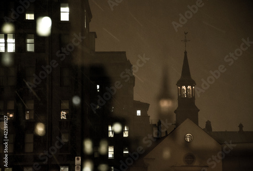 фотографія A church spire in Old Québec City, Canada, on a snowy winter night