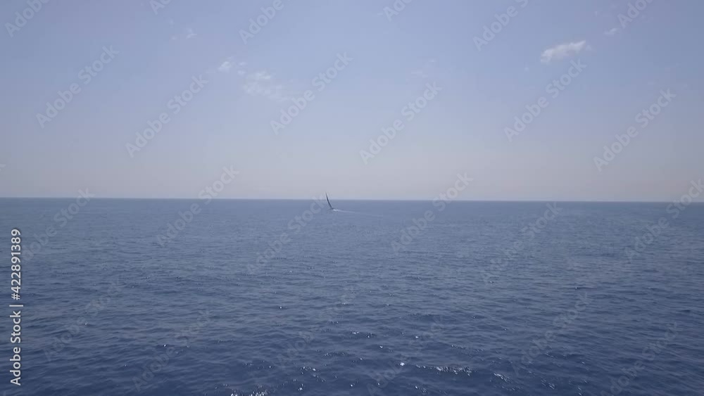 Aerial view of lonely sailing ship at sea, drone flying forwards, day Aerial view of lonely sailing ship at sea, drone flying forwards, day