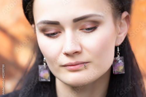 Fotografie Portrait of a beautiful young woman with a lip piercing