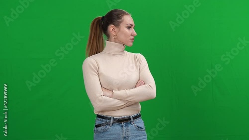Nervous woman looking around with worried facial expression on green screen. Middle shot of stressed Caucasian lady gets scared at chromakey background. Panic and fear concept.