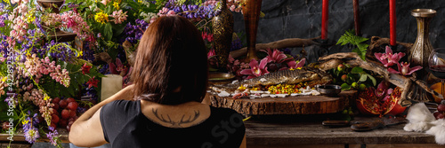 Decorator at work. Still life in old masters style. Flowers, fruits. The concept of a richly decorated table. Banner.