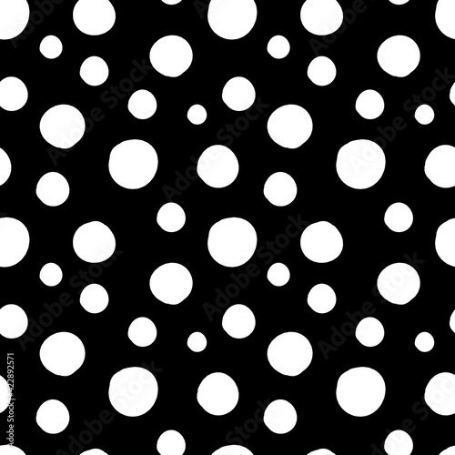 Vector seamless pattern of white hand-drawn circles polka dot isolated on a black background