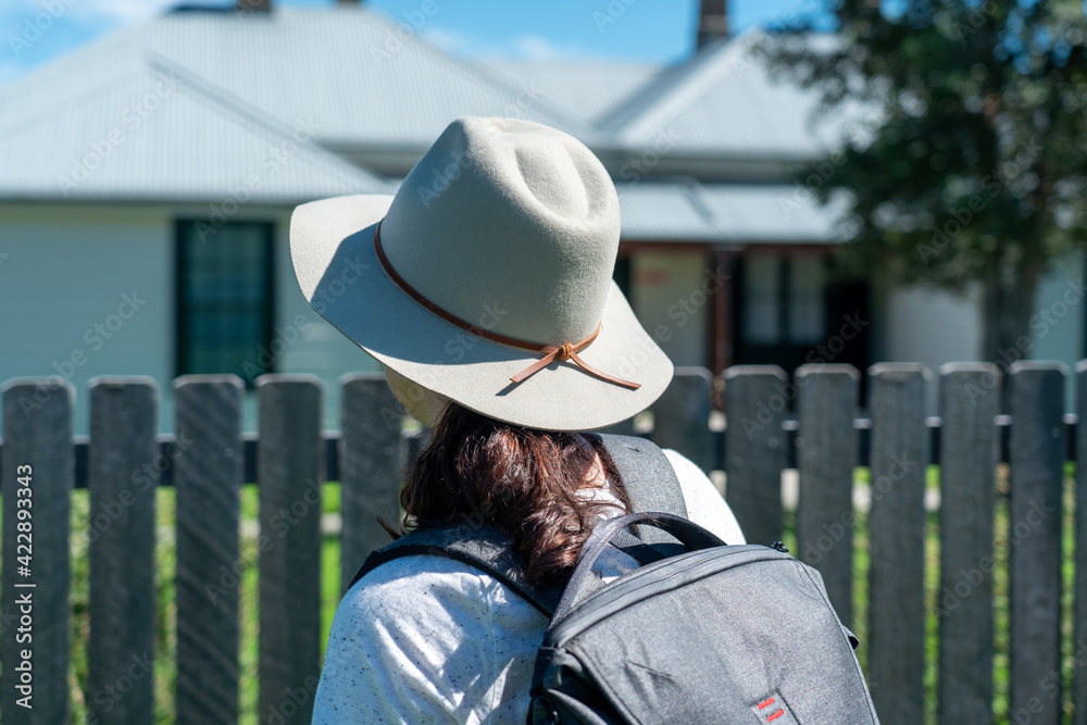 Woman outdoors hiking wearing broad brim hat