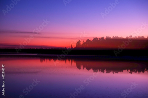 Double exposure of a sunset over a lake in the Boundary Waters, Minnesota, USA