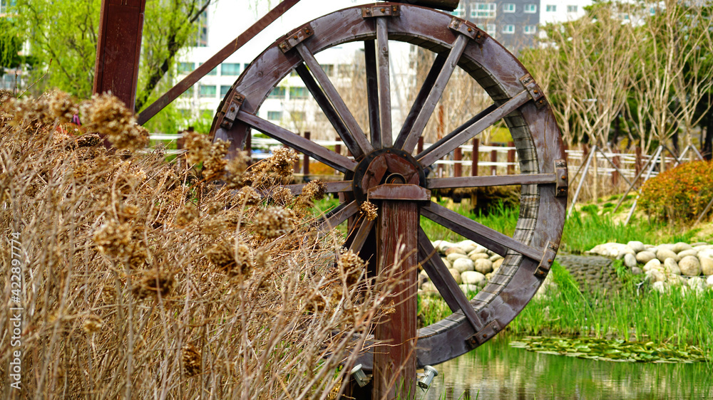 a waterwheel by a stream in the park a waterwheel by a stream in the park