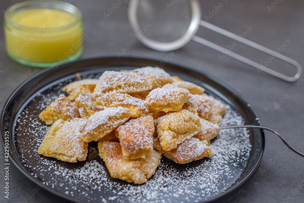 Austrian cuisine. Torn pancake (or omelet) kaiserschmarrn with honey, powdered sugar