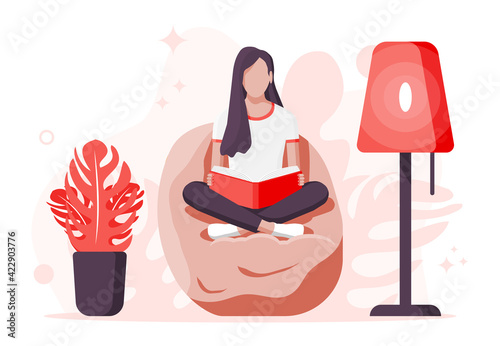 Young woman sitting cross-legged and read book.