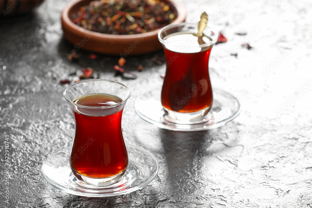 Cups with hot Turkish tea on dark background