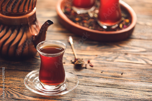 Cup with hot Turkish tea on wooden background