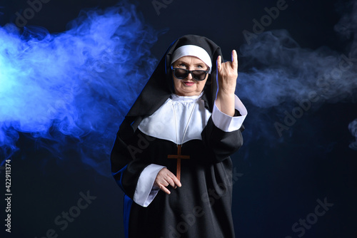 Cool senior nun showing "de...