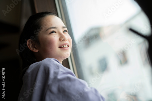 Girl Looking Out Window photo