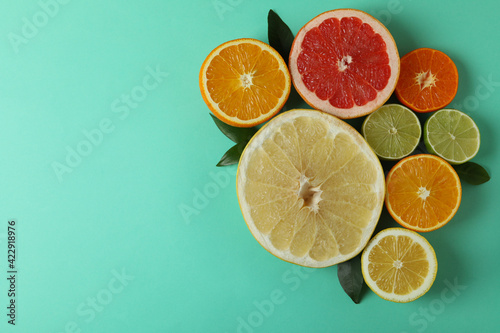 Fototapeta Naklejka Na Ścianę i Meble -  Ripe citrus on mint background, space for text