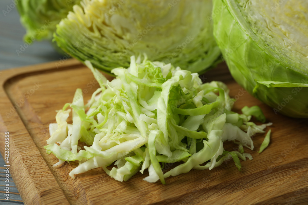 Board with fresh green cabbage on wooden background Board with fresh green cabbage on wooden background