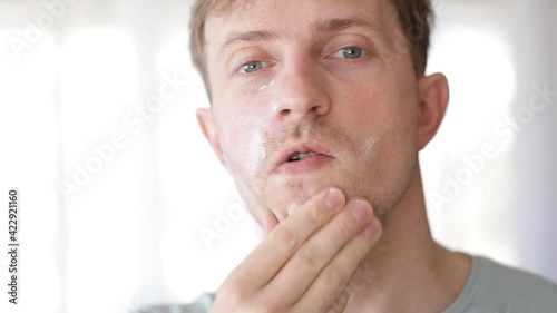 man with moisturizer on the face