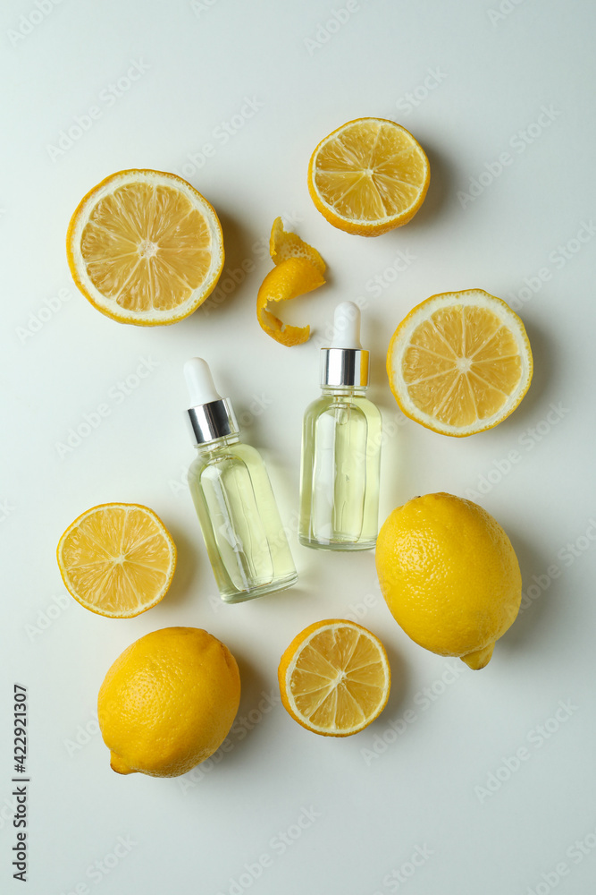 Dropper bottles with oil and lemons on white background Dropper bottles with oil and lemons on white background
