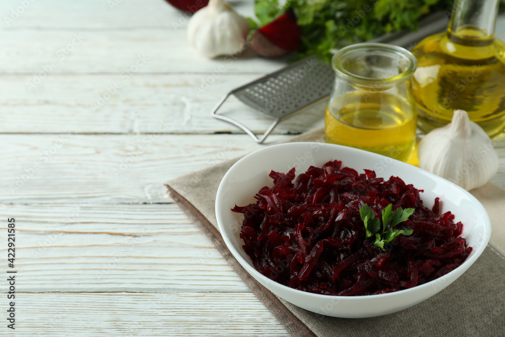 Concept of tasty eating with beet salad on white wooden background Concept of tasty eating with beet salad on white wooden background