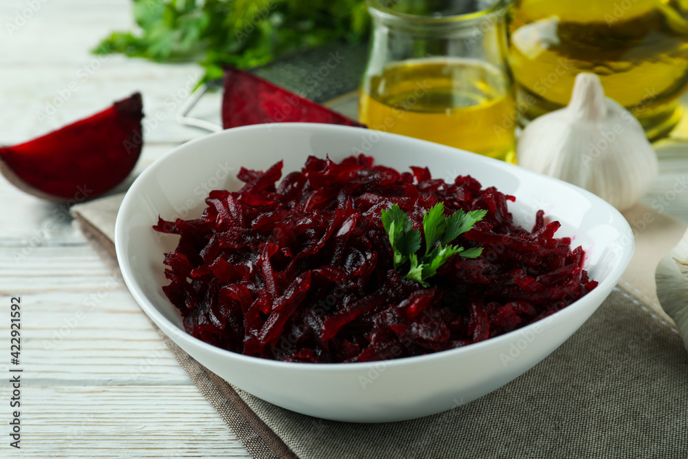 Concept of tasty eating with beet salad on white wooden background Concept of tasty eating with beet salad on white wooden background
