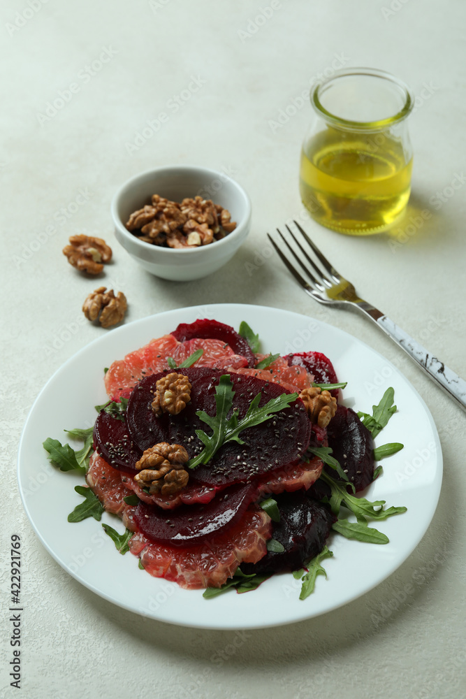 Concept of tasty eating with beet salad on white textured background Concept of tasty eating with beet salad on white textured background