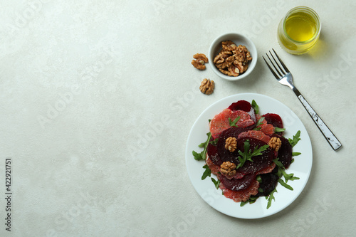 Concept of tasty eating with beet salad on white textured background