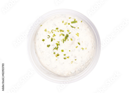 Plastic bowl of tasty cream cheese on white background