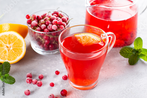 Berry tea with currants in cup on a light background. Vitamin drink, healthy food