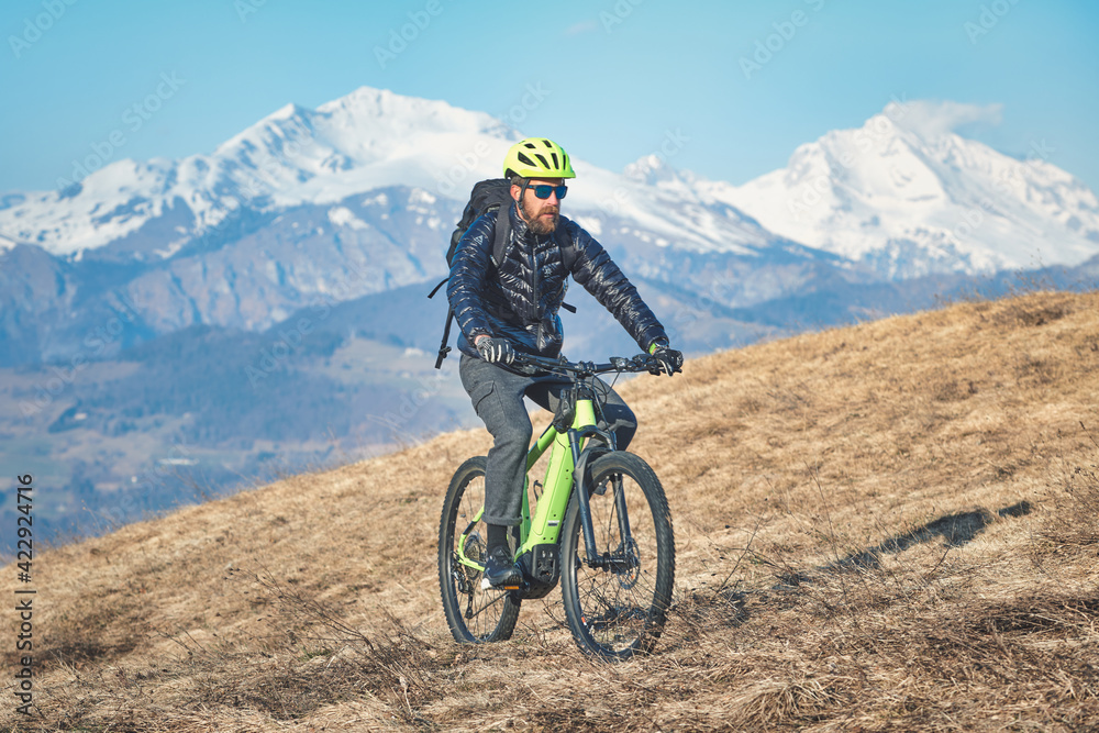 Climb in a mountain meadow with mountain bike Climb in a mountain meadow with mountain bike
