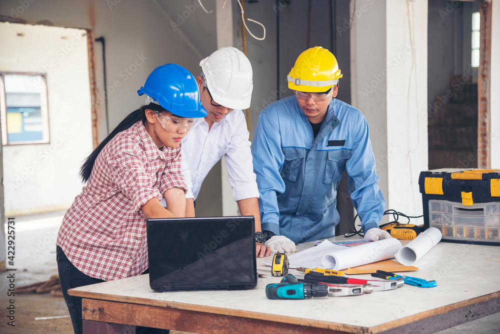 Construction engineer teamwork Safety Suit Trust Team Holding White Yellow Safety hard hat Security Equipment on Construction Site. Hardhat Protect Head for Civil Construction Engineer Concept