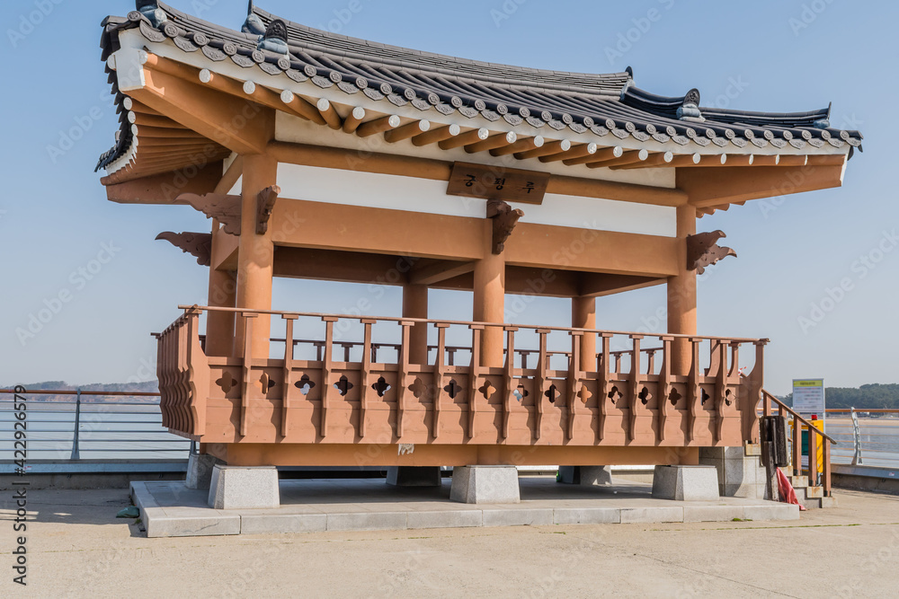 Fototapeta premium Wooden pavilion in alcove of concrete pier in small port near Pyeongtaek, South Korea.