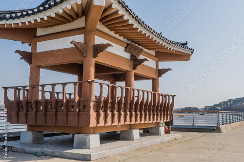 Wooden pavilion in alcove of concrete pier in small port near Pyeongtaek, South Korea.