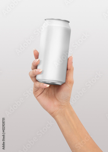 Beautiful female hand holding plain matt beverage or soft drink beer can