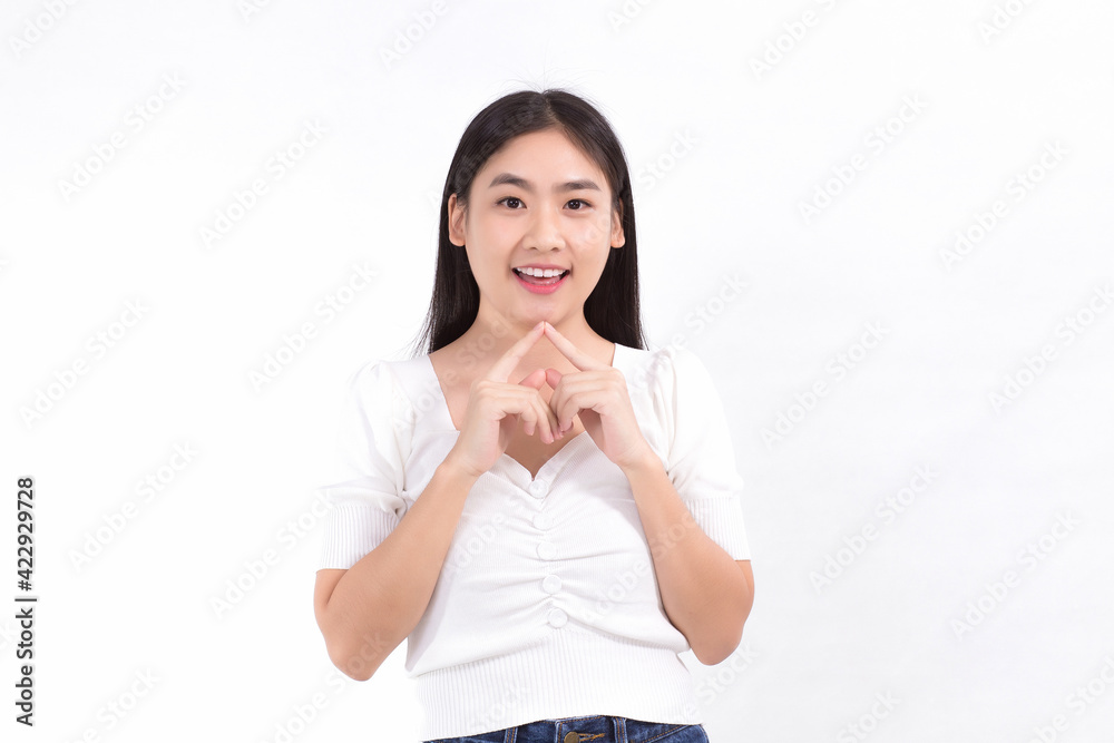 Asian beauty woman standing smiling in pink dress is looking at something while touching her face on a white background. Asian beauty woman standing smiling in pink dress is looking at something while touching her face on a white background.