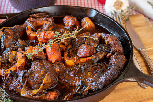 Braised beef shanks in a cast iron pan