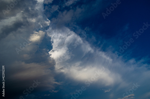 Cumulus clouds in a blue sky.