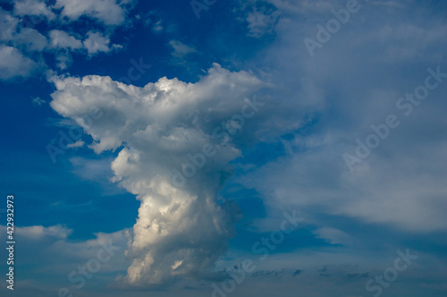Cumulus clouds in a blue sky. © Oleg