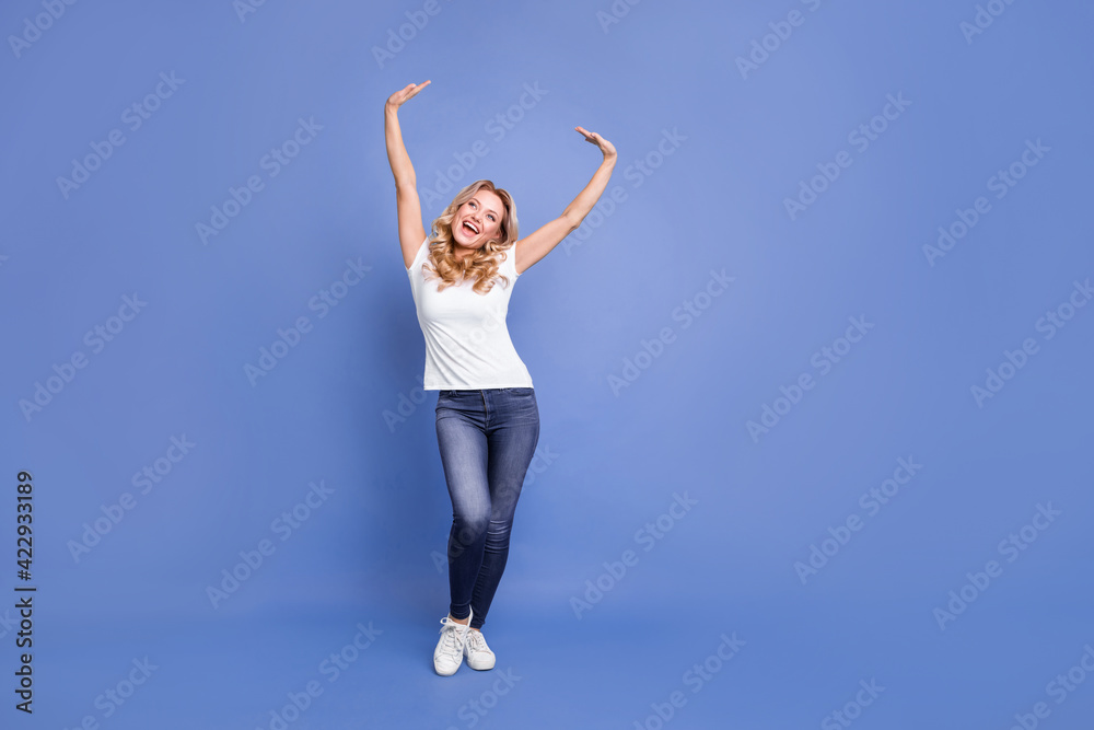 Full body photo of young excited woman happy positive smile enjoy rejoice look empty space isolated over blue color background