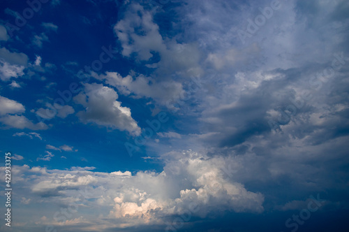 Cumulus clouds in a blue sky. © Oleg