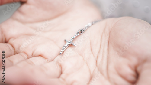 woman hand with a cross and a bible