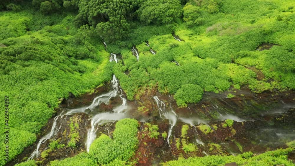 Poco Ribeira do Ferreiro, Alagoinha, Flores Island, Azores, Portugal. Aerial footage of untouched natural landscape. Vibrant slopes covered with moss and lush vegetation. High quality 4k footage