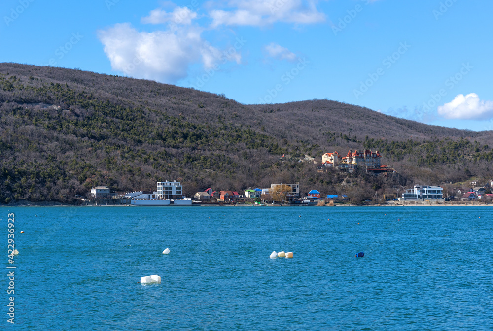 Panoramic view of Lake Abrau Dyurso in Krasnodar Krai, Russia. Picturesque view of blue lake with church on sunny spring day in Abrau Durso.