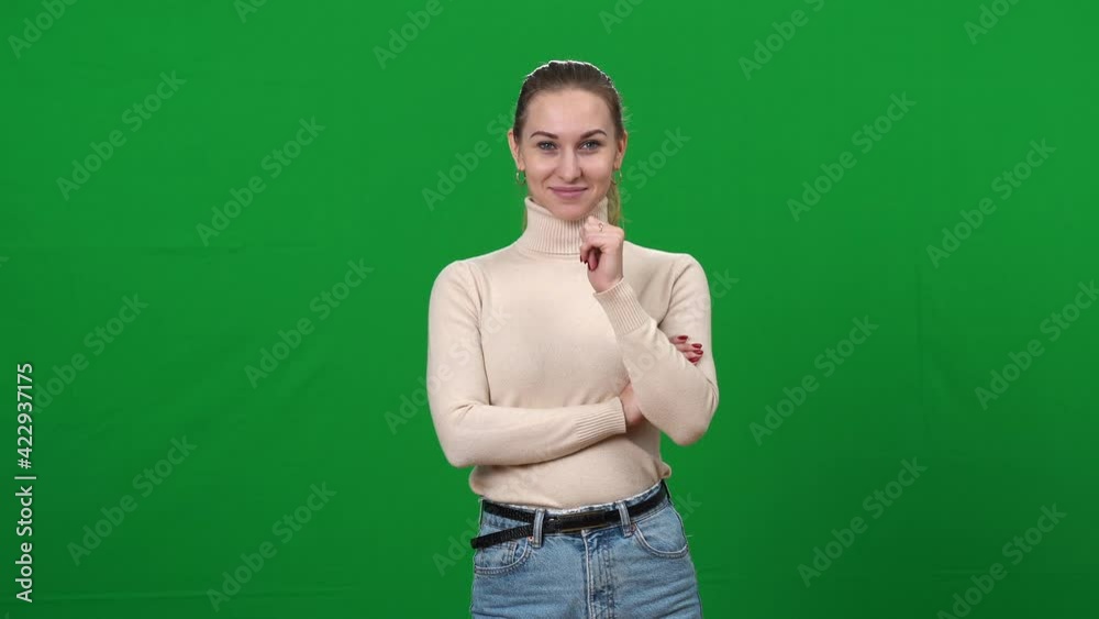 Positive charming Caucasian woman pointing at camera smiling. Portrait of joyful young slim lady posing at green screen chromakey background. Lifestyle and happiness. Positive charming Caucasian woman pointing at camera smiling. Portrait of joyful young slim lady posing at green screen chromakey background. Lifestyle and happiness.