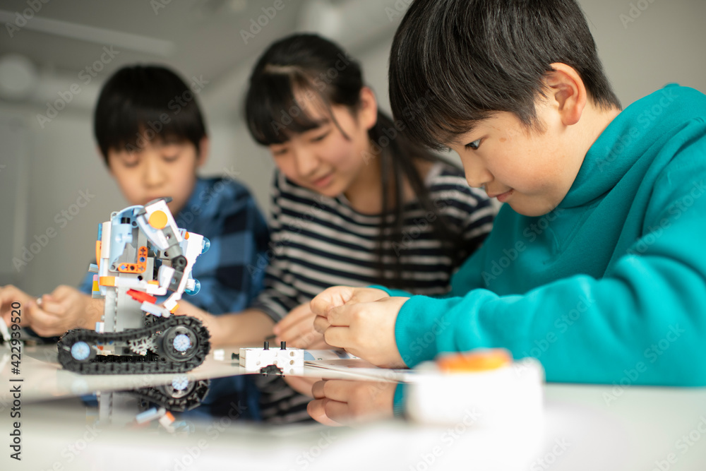 Elementary School Students Assembling Programming Robot Elementary School Students Assembling Programming Robot
